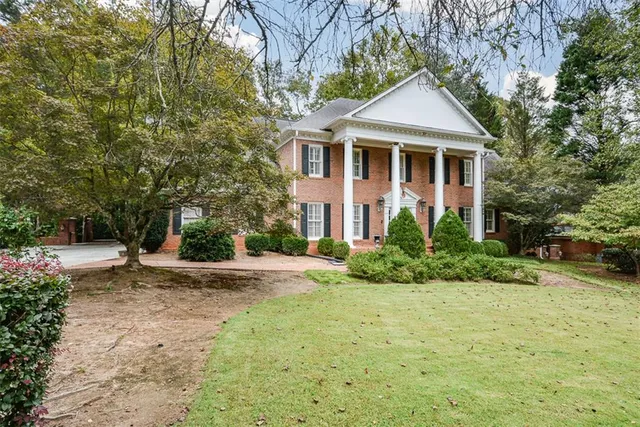 a living room with furniture a fireplace and a floor to ceiling window
