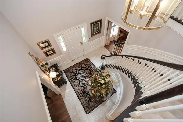 a living room with furniture a fireplace and a floor to ceiling window