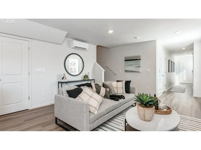 a living room with furniture and a mirror