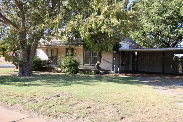 a view of a house with pool and a bench