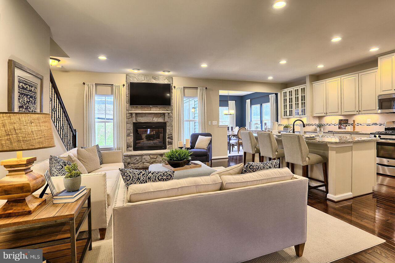3142 Sunny Ridge Drive Odenton, MD 21113 - Photo 6 of 30 a living room with fireplace furniture and a flat screen tv