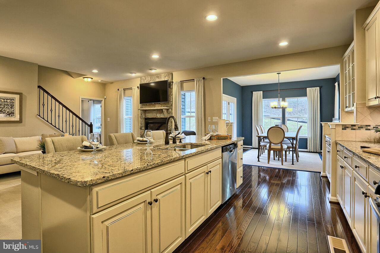 3142 Sunny Ridge Drive Odenton, MD 21113 - Photo 9 of 30 a open kitchen with stainless steel appliances granite countertop a lot of counter space and wooden floors