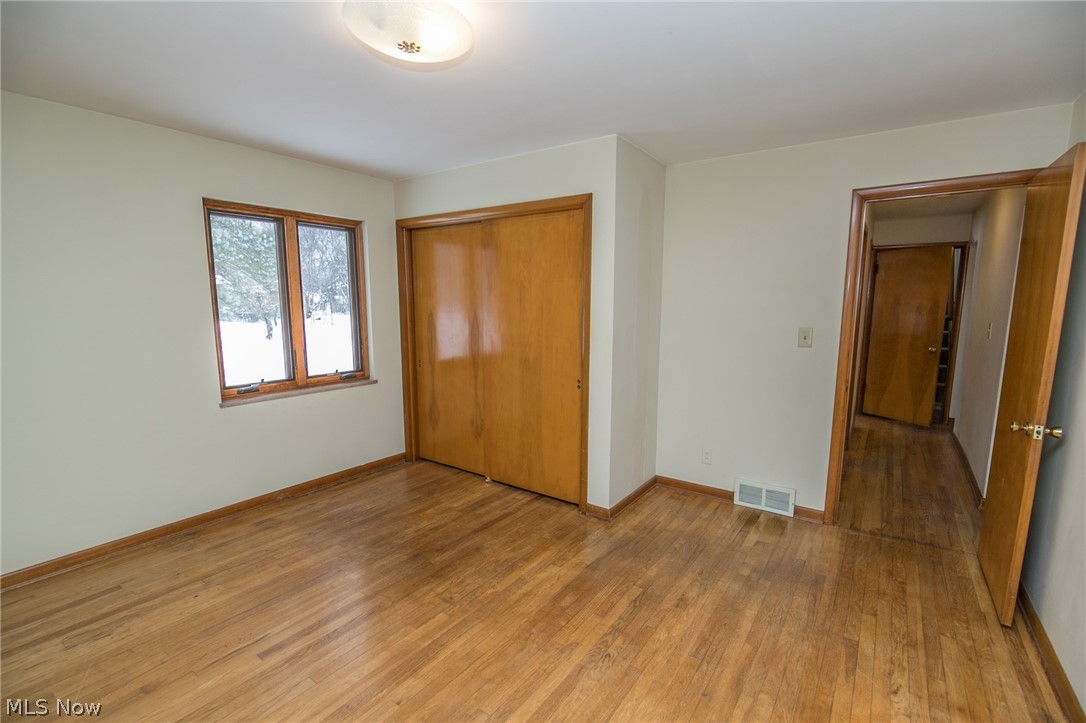 6473 Crossview Road Independence, OH 44131 - Photo 14 of 28 First Floor Bedroom; hardwood flooring and Jelwen replacement windows.