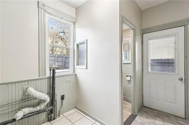 a view of a livingroom with a chandelier fan and a window