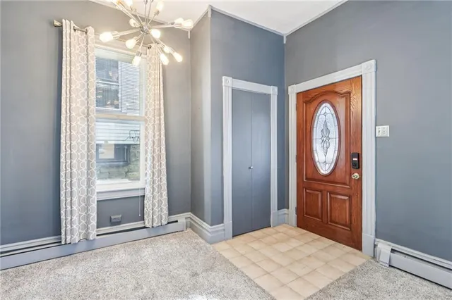 an empty room with wooden floor cabinet and windows
