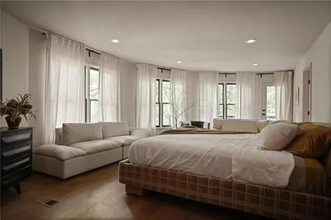 a bedroom with a bed and a couch