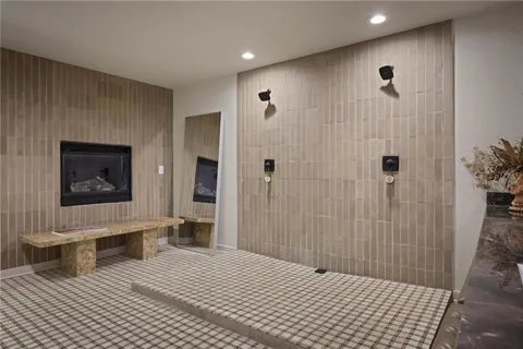 a bathroom with a sink a toilet a mirror and shower