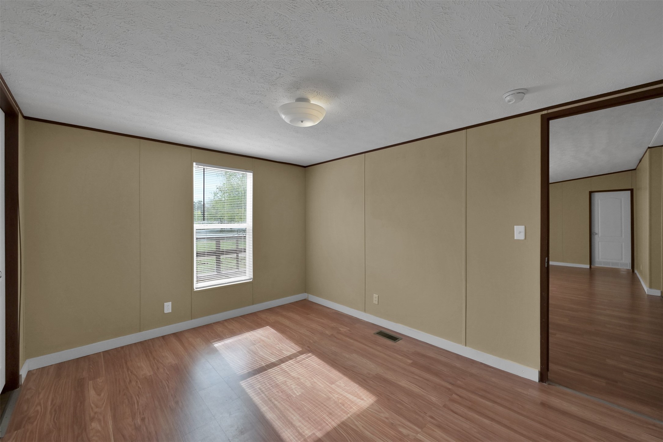 25414 T K C Road Tomball, TX 77375 - Photo 15 of 17 an empty room with wooden floor and windows