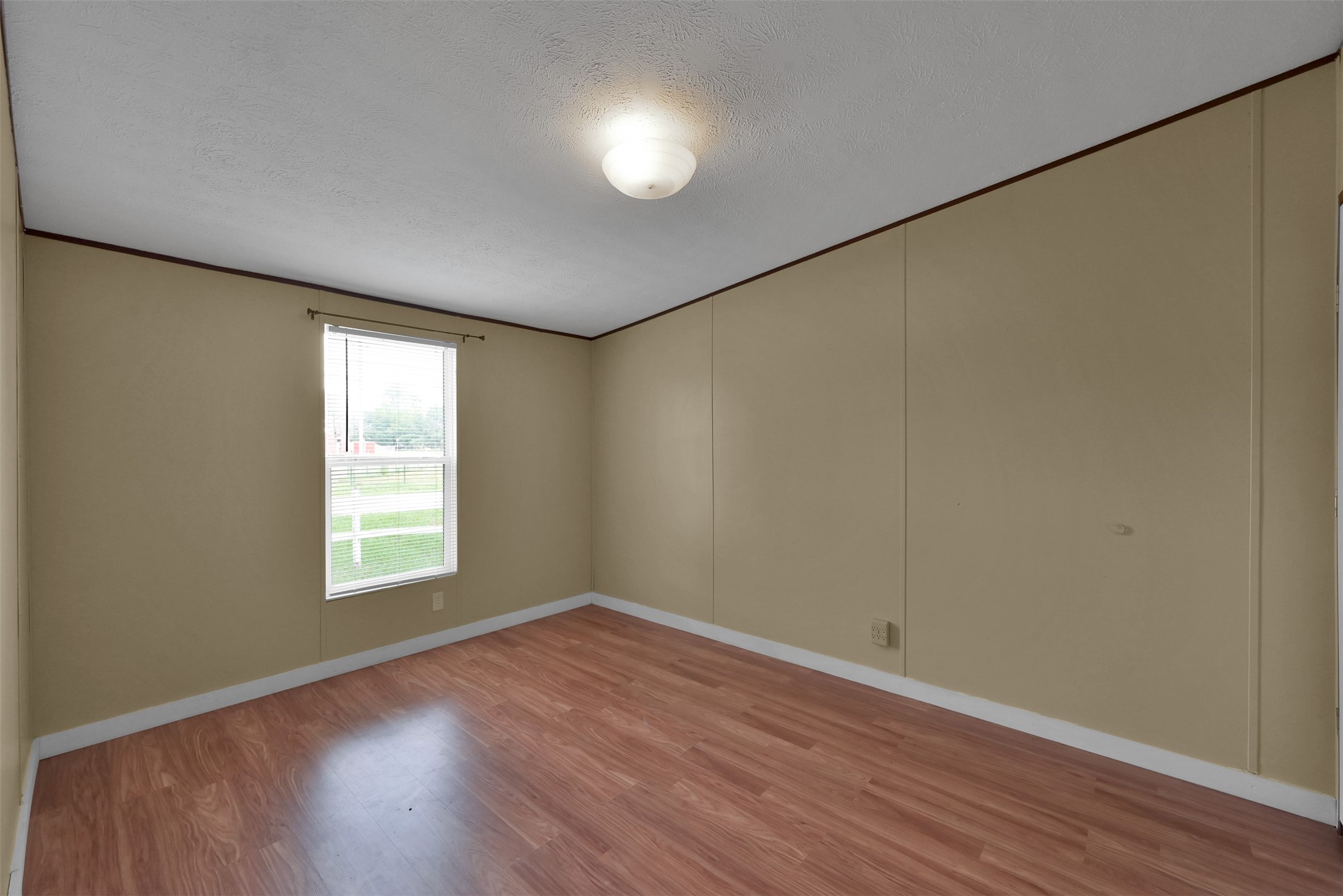 25414 T K C Road Tomball, TX 77375 - Photo 17 of 17 an empty room with wooden floor and windows