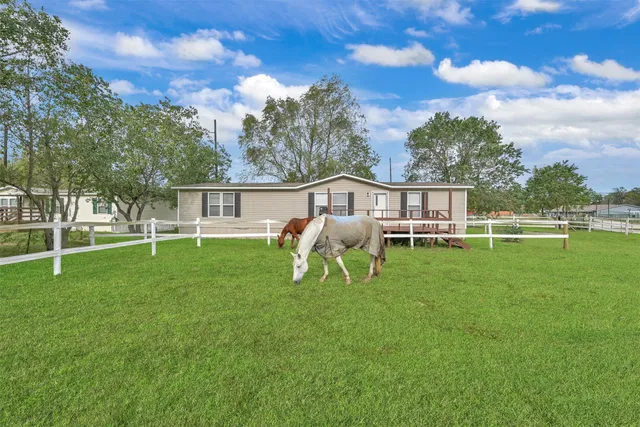 a view of a house with a backyard