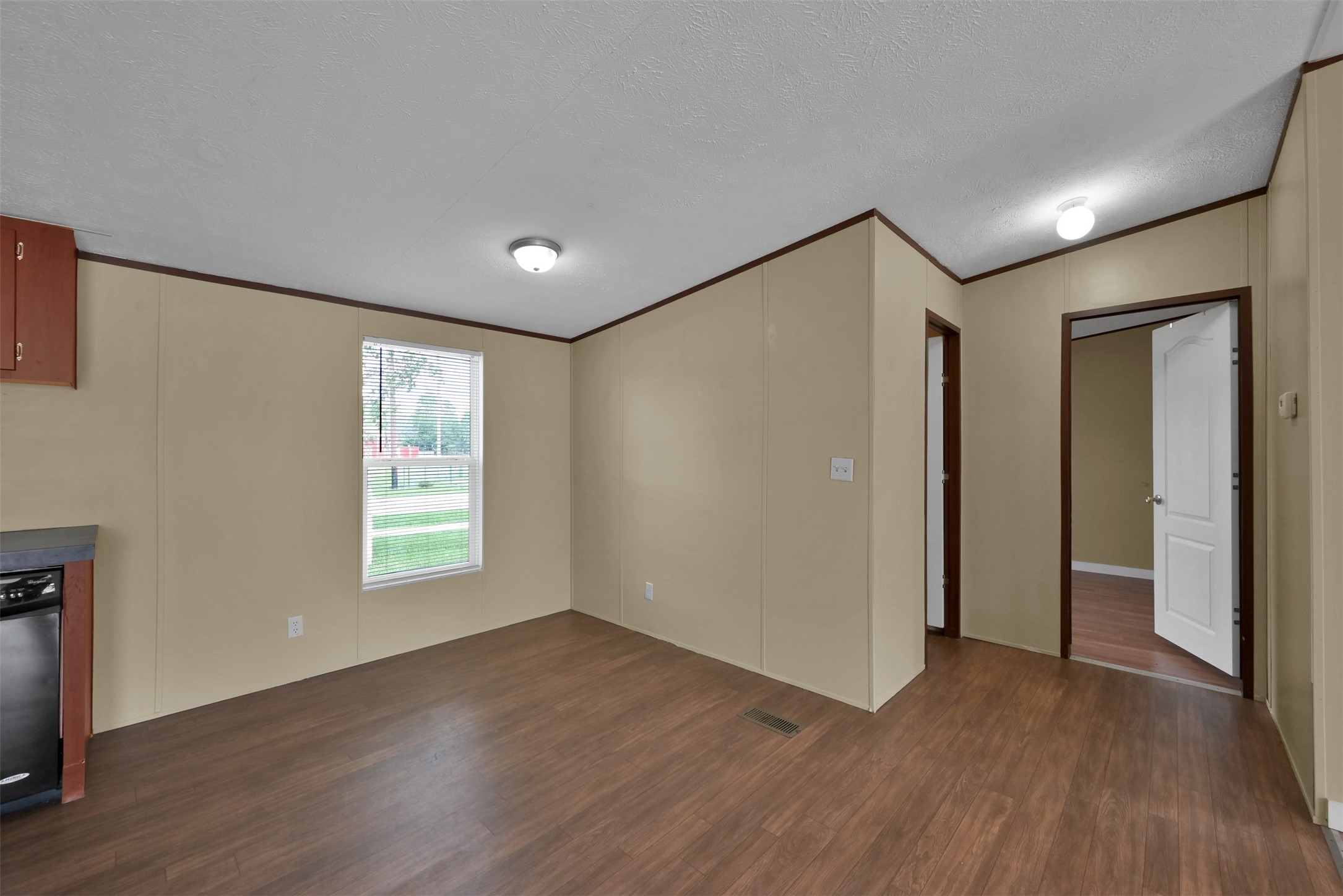 25414 T K C Road Tomball, TX 77375 - Photo 10 of 17 a view of an empty room with wooden floor and a window
