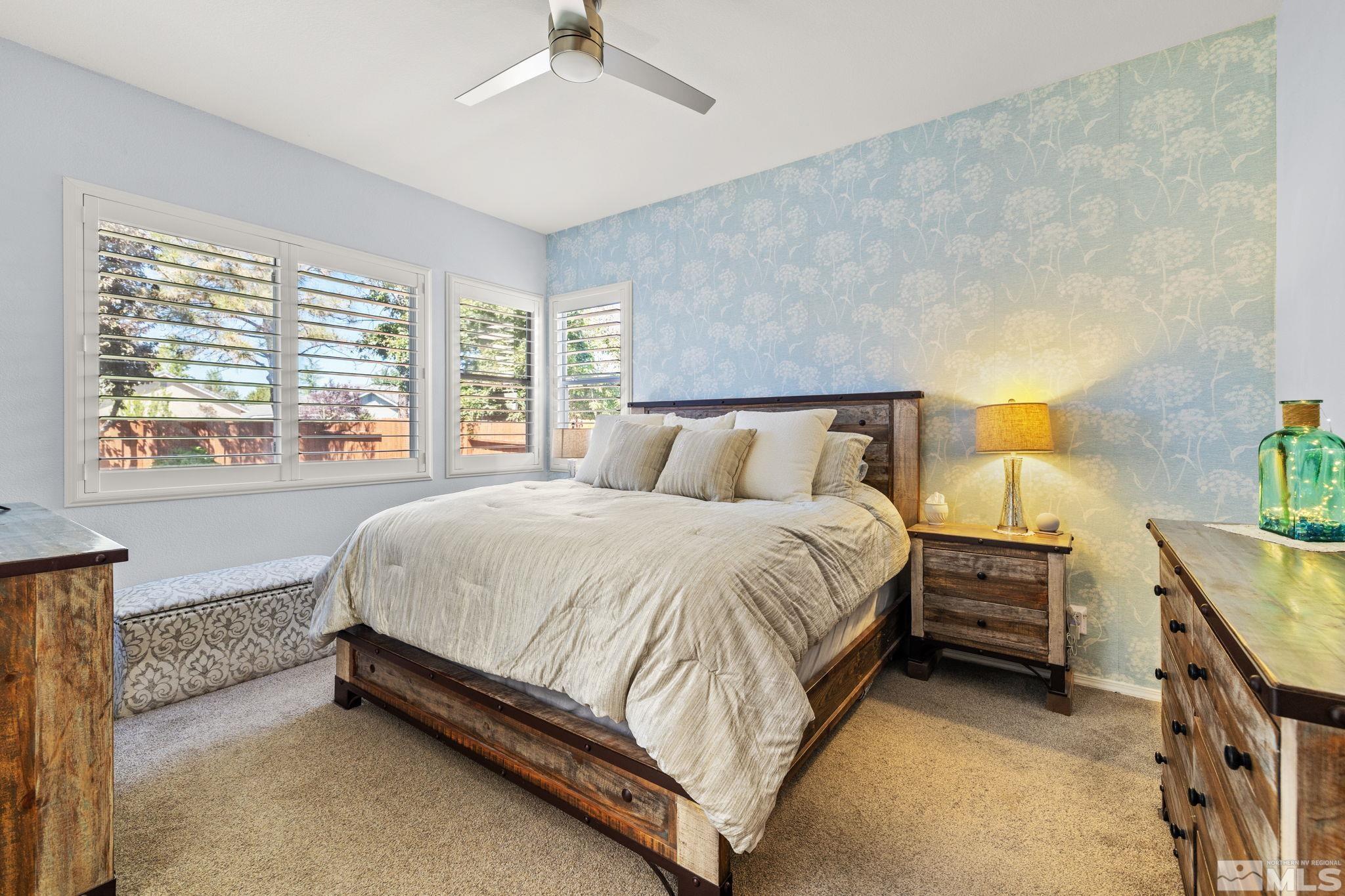 9873 Northrup Drive Reno, NV 89521 - Photo 12 of 24 a bed sitting in a bedroom next to a window