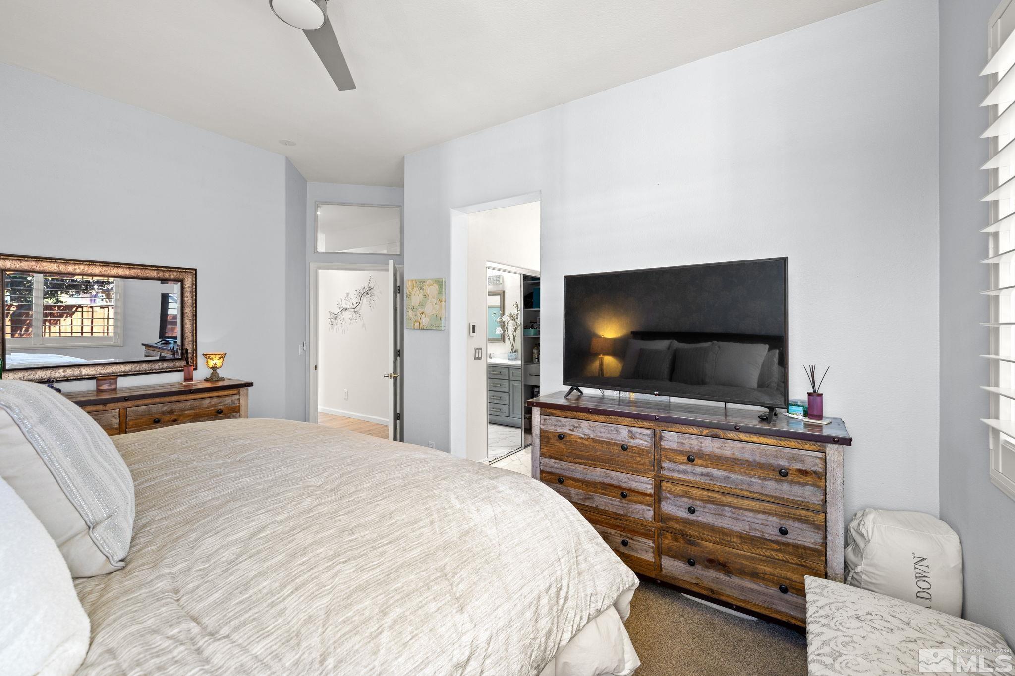 9873 Northrup Drive Reno, NV 89521 - Photo 13 of 24 a bedroom with a bed and a flat screen tv