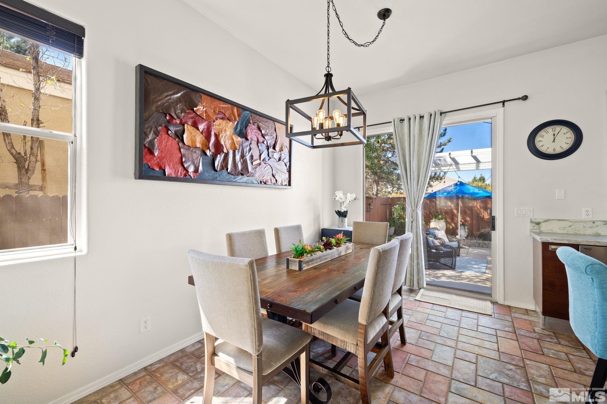 9873 Northrup Drive Reno, NV 89521 - Photo 7 of 24 a view of a dining room with furniture a chandelier and wooden floor