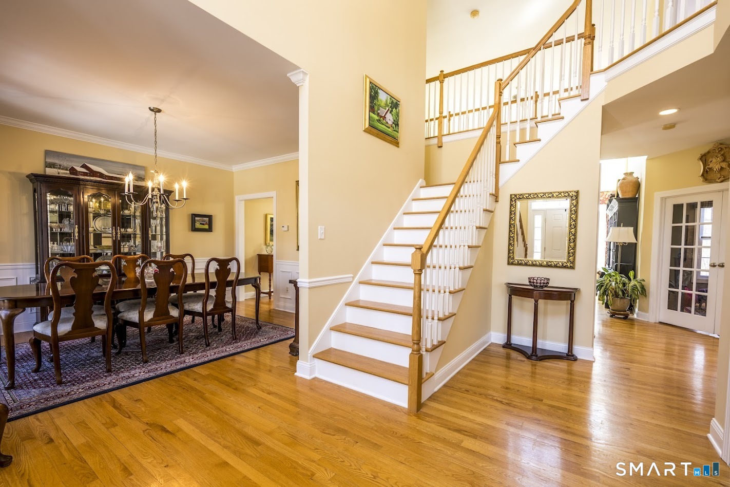 22 R Olde Yankee Way Durham, CT 06422 - Photo 12 of 29 Welcoming two-story foyer with hardwood floors, open staircase, and elegant flow to formal dining and main living areas.