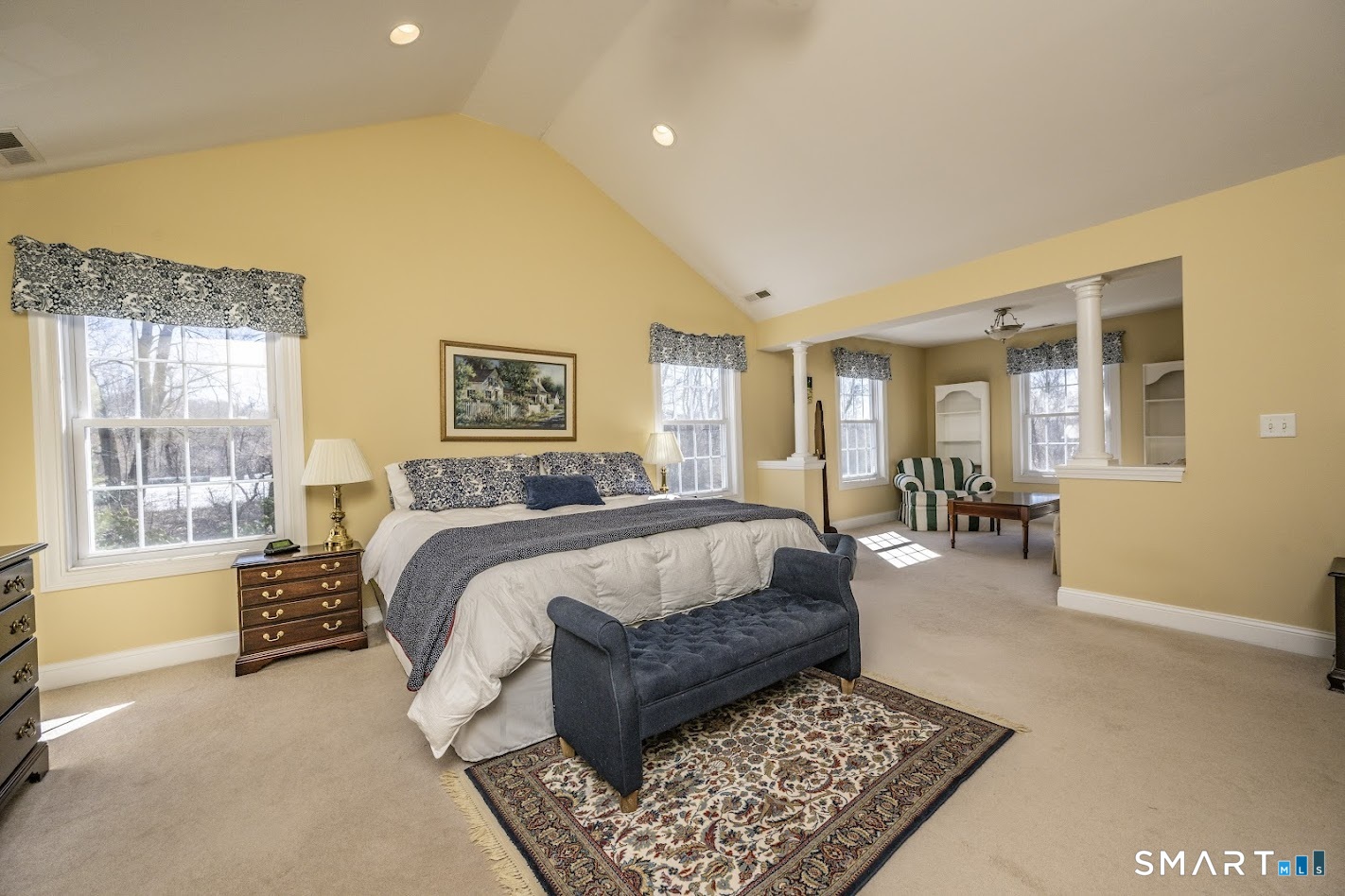 22 R Olde Yankee Way Durham, CT 06422 - Photo 16 of 29 Expansive primary bedroom with vaulted ceiling, large windows, and comfortable space for sitting area.