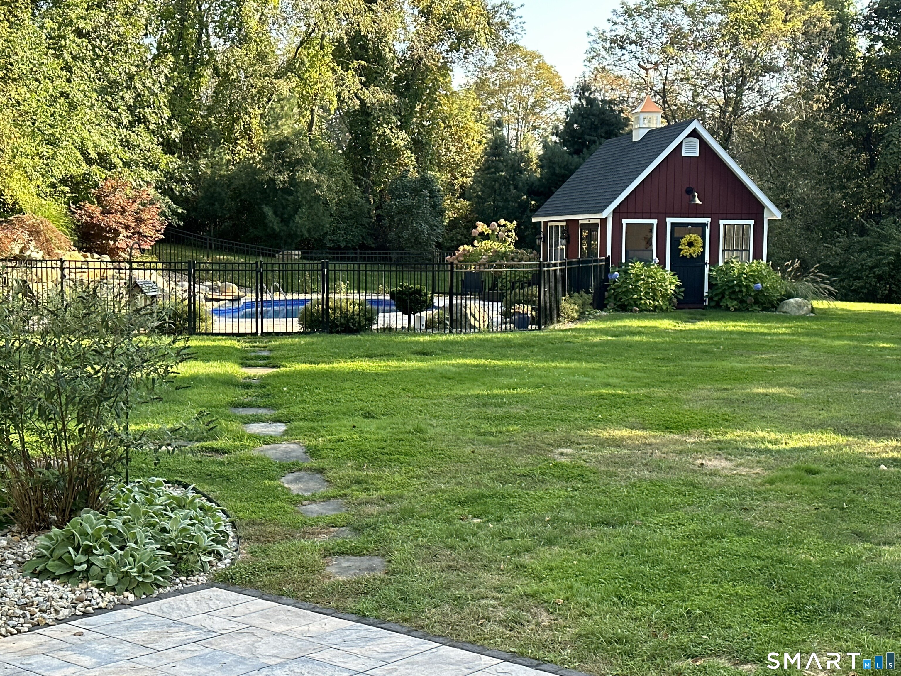 22 R Olde Yankee Way Durham, CT 06422 - Photo 27 of 29 Expansive backyard setting with fenced inground pool and charming pool house - ideal for outdoor enjoyment and entertaining.