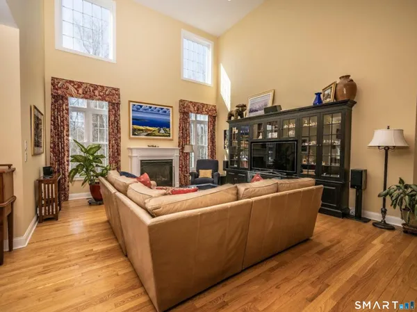 a living room with furniture a fireplace and a table