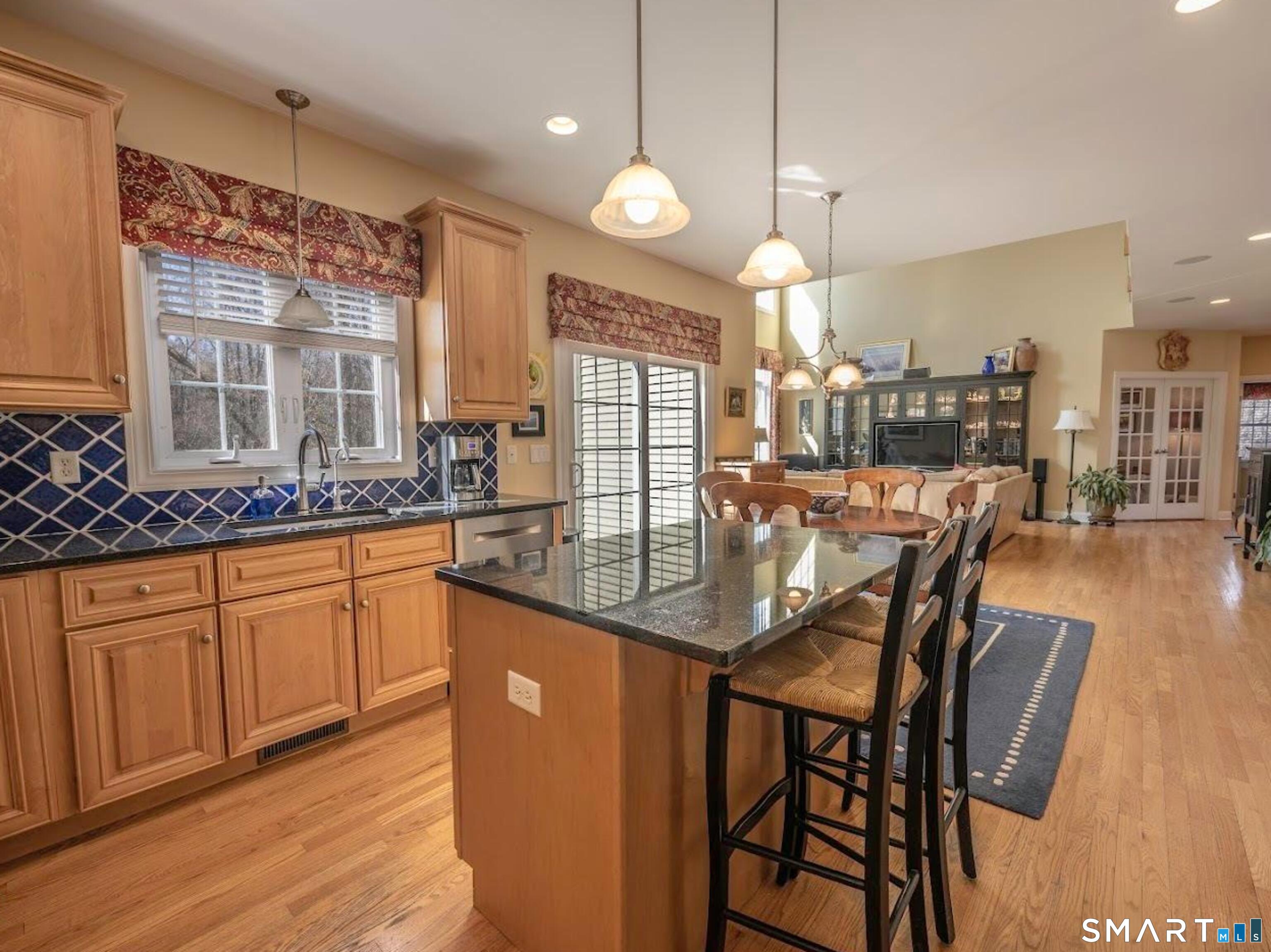 22 R Olde Yankee Way Durham, CT 06422 - Photo 9 of 29 Open-concept kitchen with hardwood floors and seamless flow to dining area and dramatic cathedral-ceiling family room.