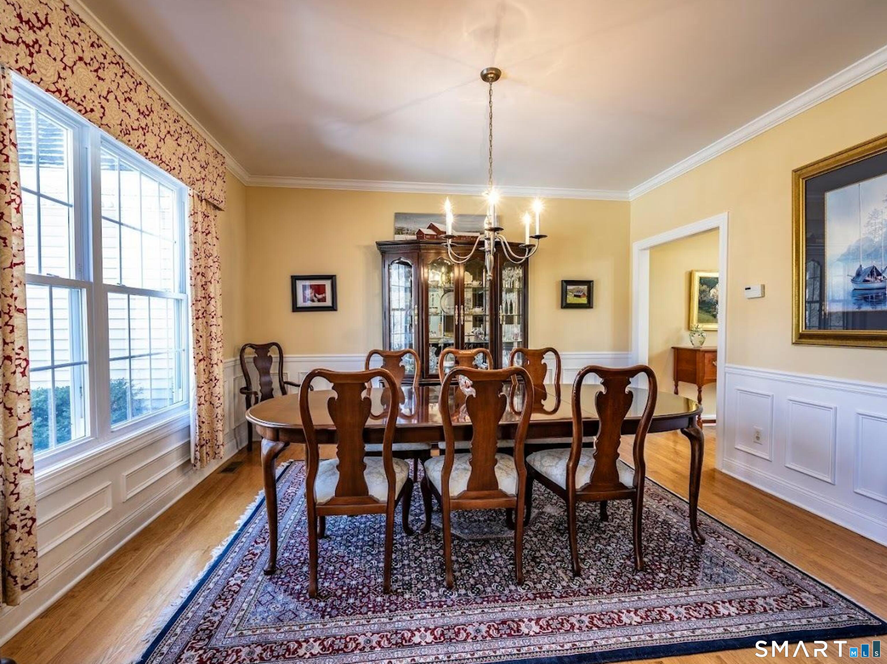 22 R Olde Yankee Way Durham, CT 06422 - Photo 10 of 29 Elegant formal dining room with hardwood floors, detailed trim, and large windows providing abundant natural light - perfect for entertaining.