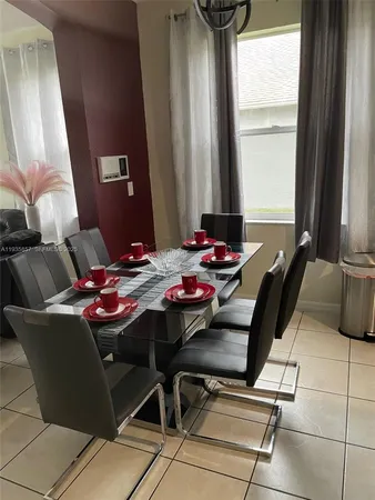 a dining room with furniture and window