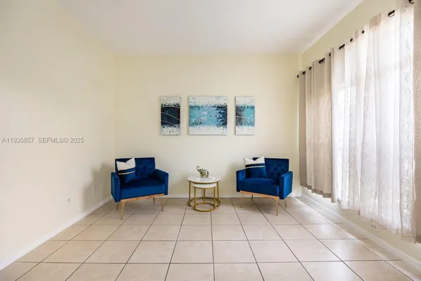 a living room with furniture and a baby crib
