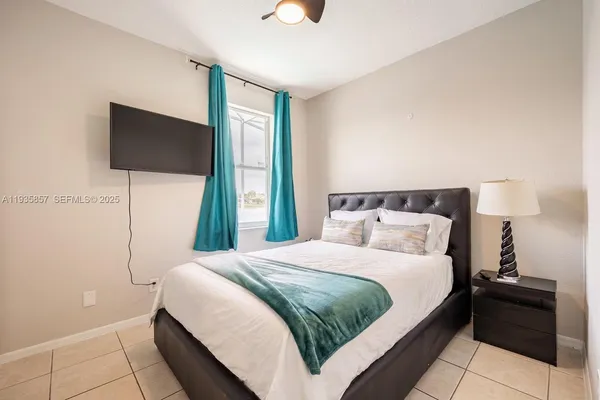 a bedroom with a bed and a flat screen tv