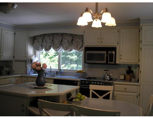 7 Stuart Place Westfield, MA 01085 - Photo 9 of 20 a kitchen with a stove a sink and a microwave
