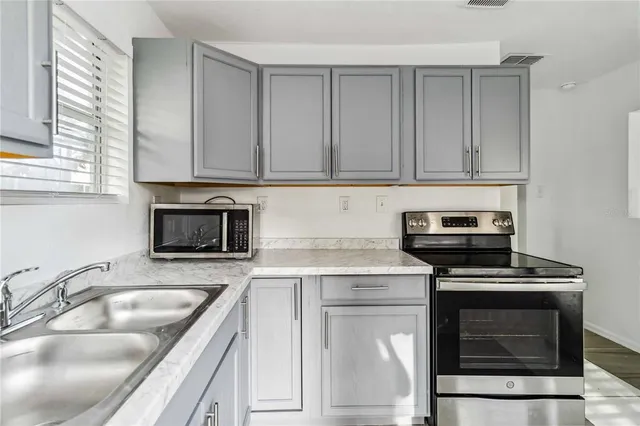 a kitchen with cabinets appliances and a sink