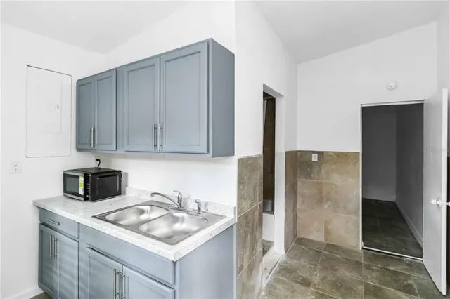 a kitchen with a sink and a refrigerator