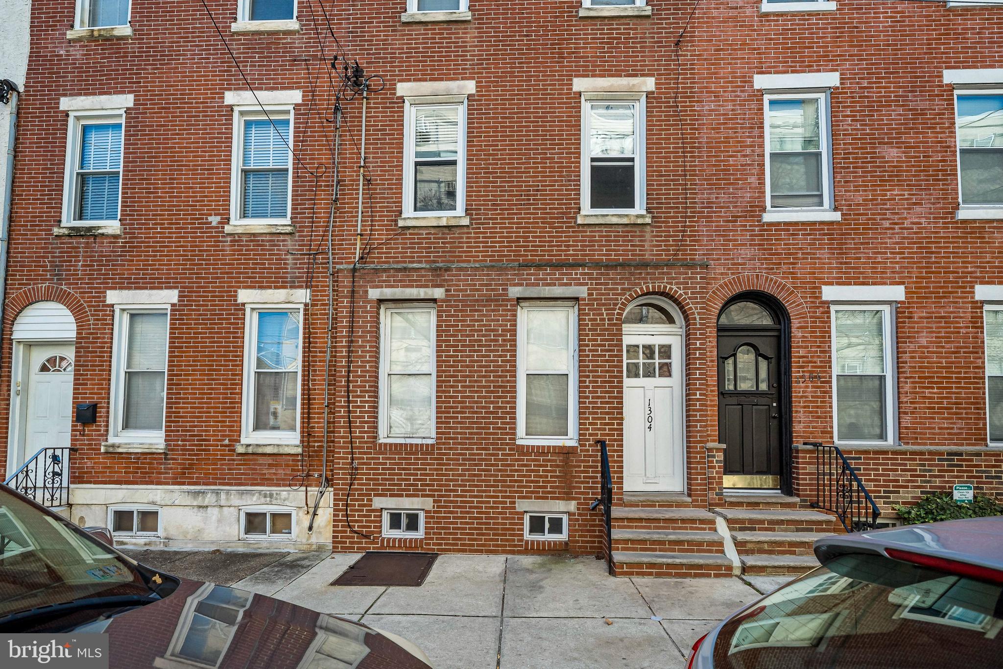 1304 Jackson Street, Unit 1 Philadelphia, PA 19148 - Photo 1 of 16 a front view of a brick building with many windows