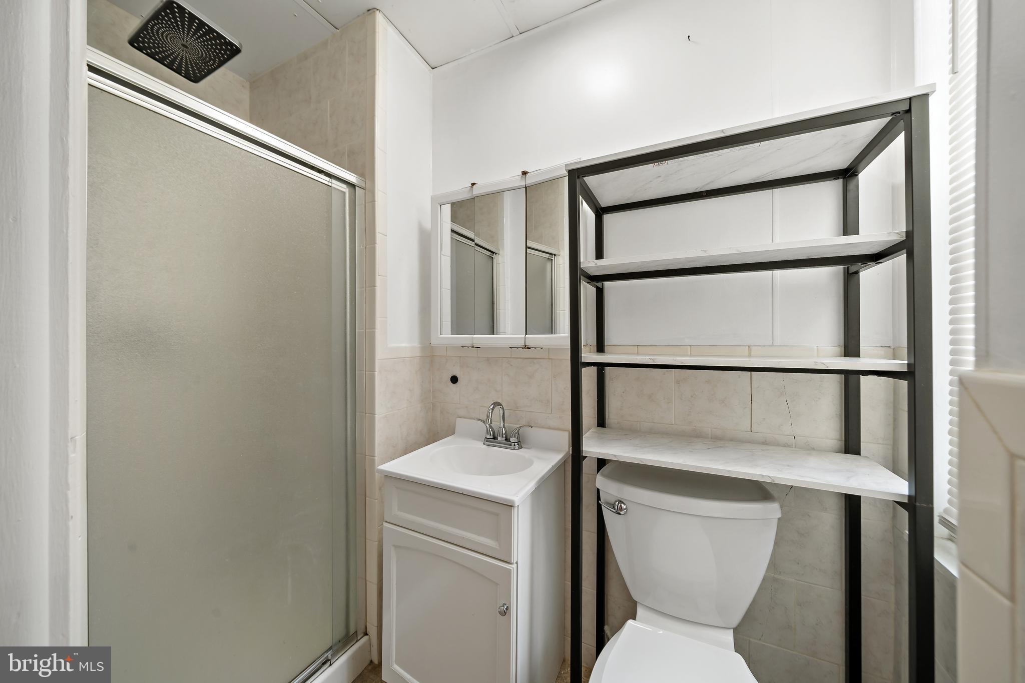1304 Jackson Street, Unit 1 Philadelphia, PA 19148 - Photo 2 of 16 a bathroom with a toilet sink and a shower
