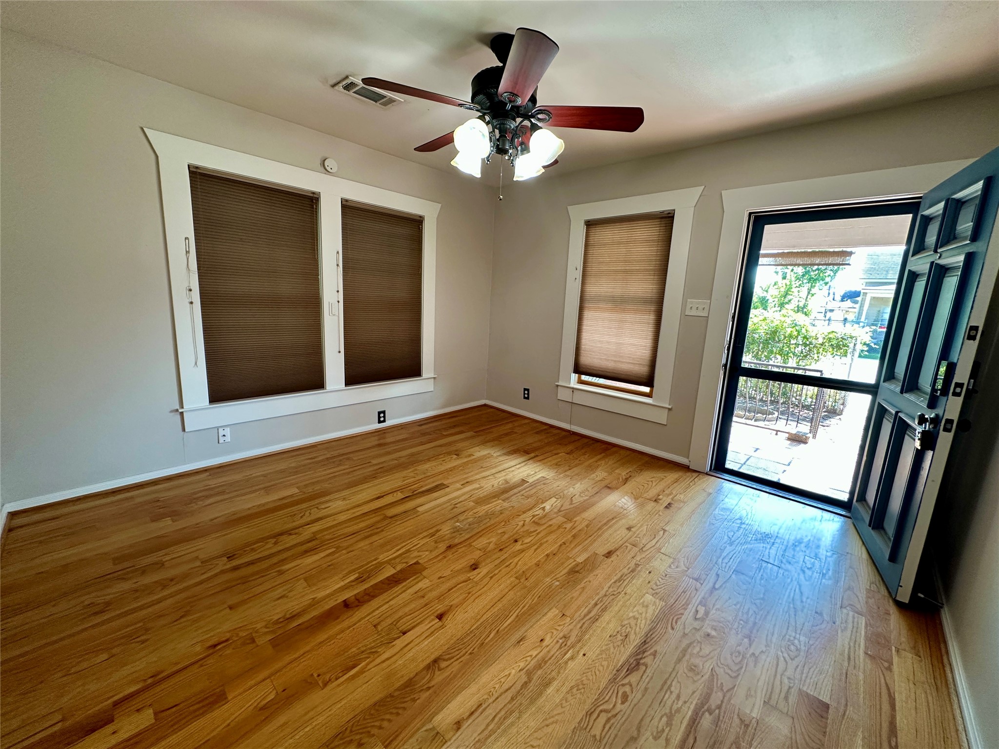 405 James, Unit 2 Houston, TX 77009 - Photo 4 of 12 a view of an empty room with wooden floor and a window