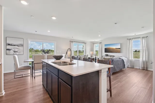 a room with furniture a large window and a wooden floor