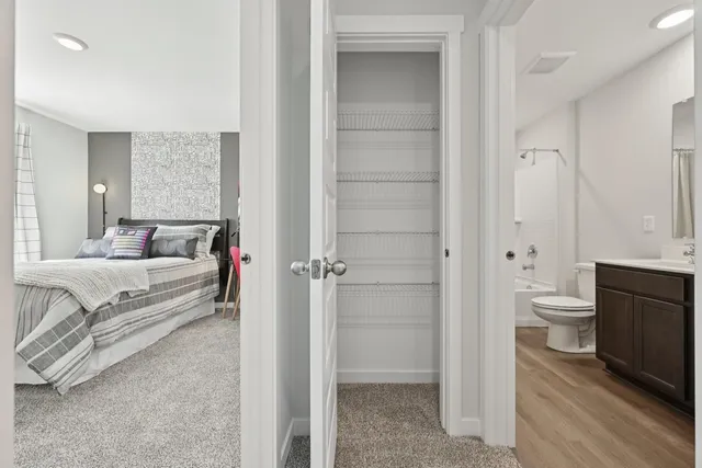 a en suite bathroom with a granite countertop toilet sink and shower