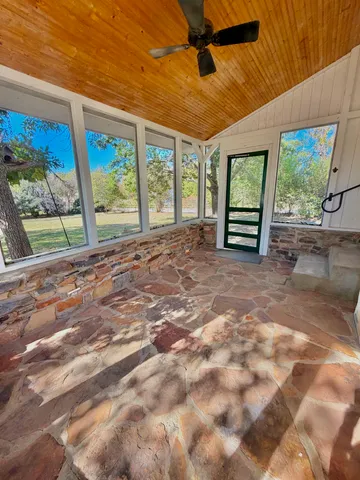 a view of empty room with large windows