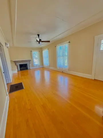wooden floor in an empty room with a window