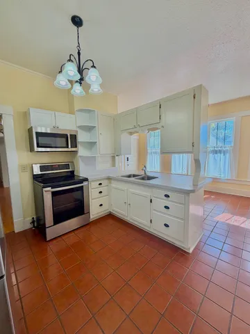 a kitchen with a stove and a microwave