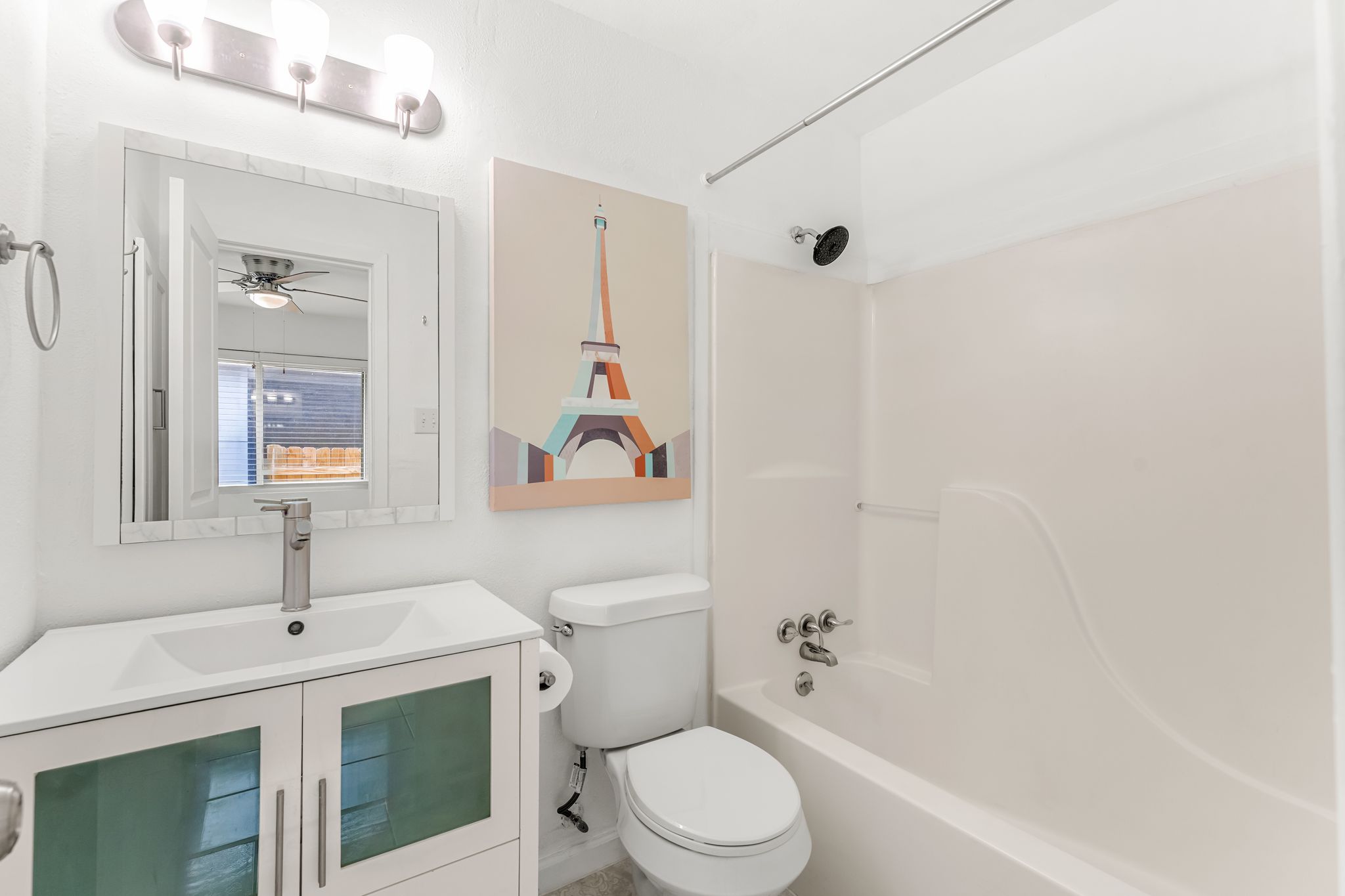 2501 Teri Road, Unit B Austin, TX 78744 - Photo 17 of 21 Contemporary bathroom featuring a white vanity with a rectangular sink, brushed nickel faucet, and integrated storage
