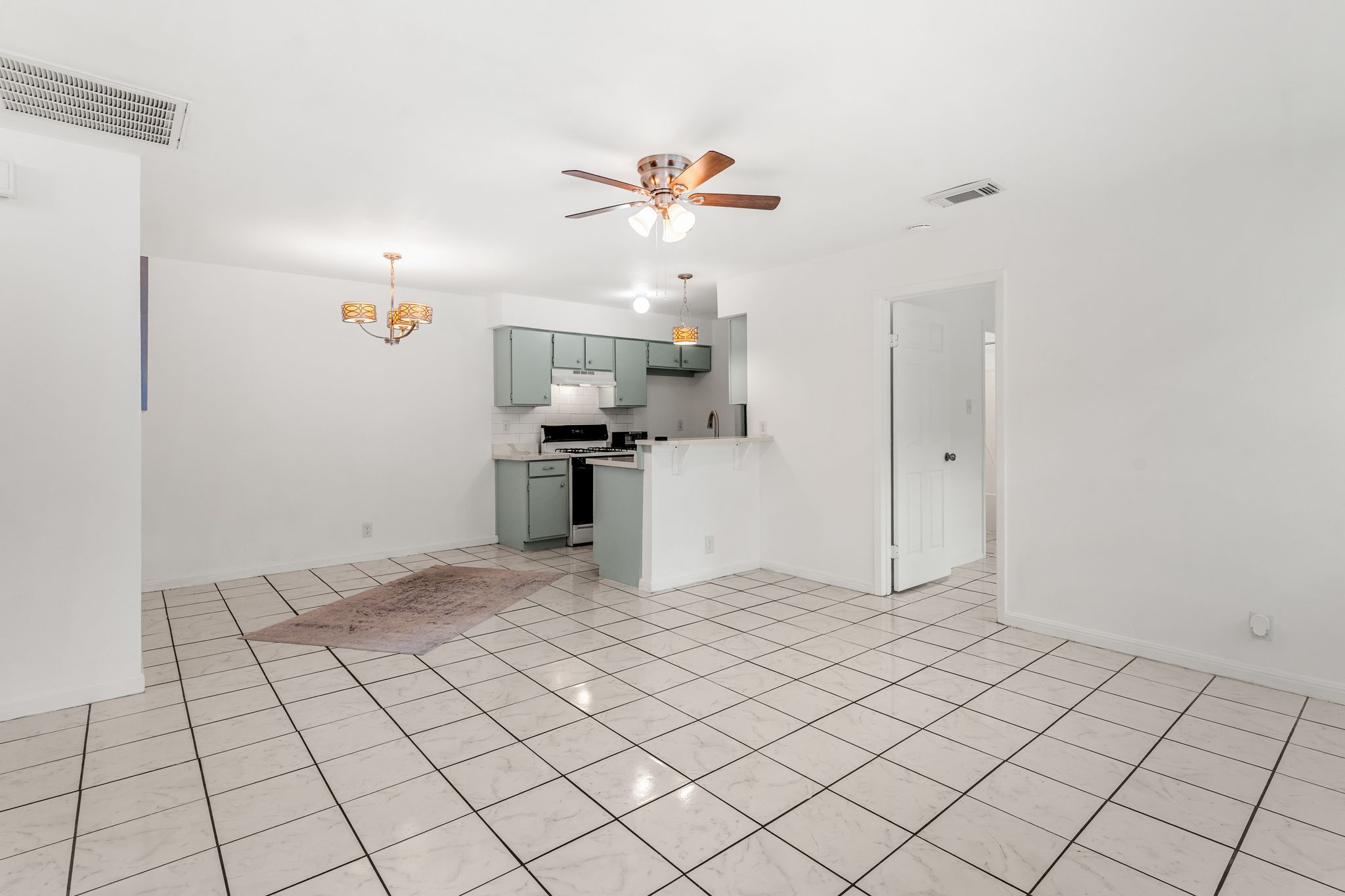 2501 Teri Road, Unit B Austin, TX 78744 - Photo 4 of 21 Open-concept living area with large square tile flooring