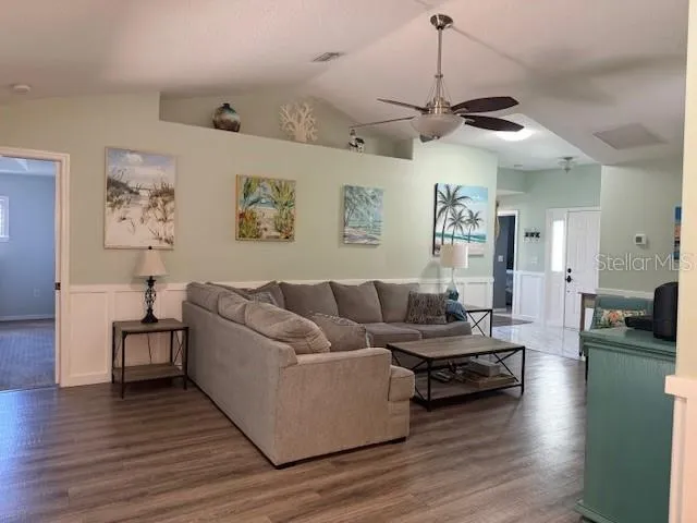 a living room with furniture and wooden floor