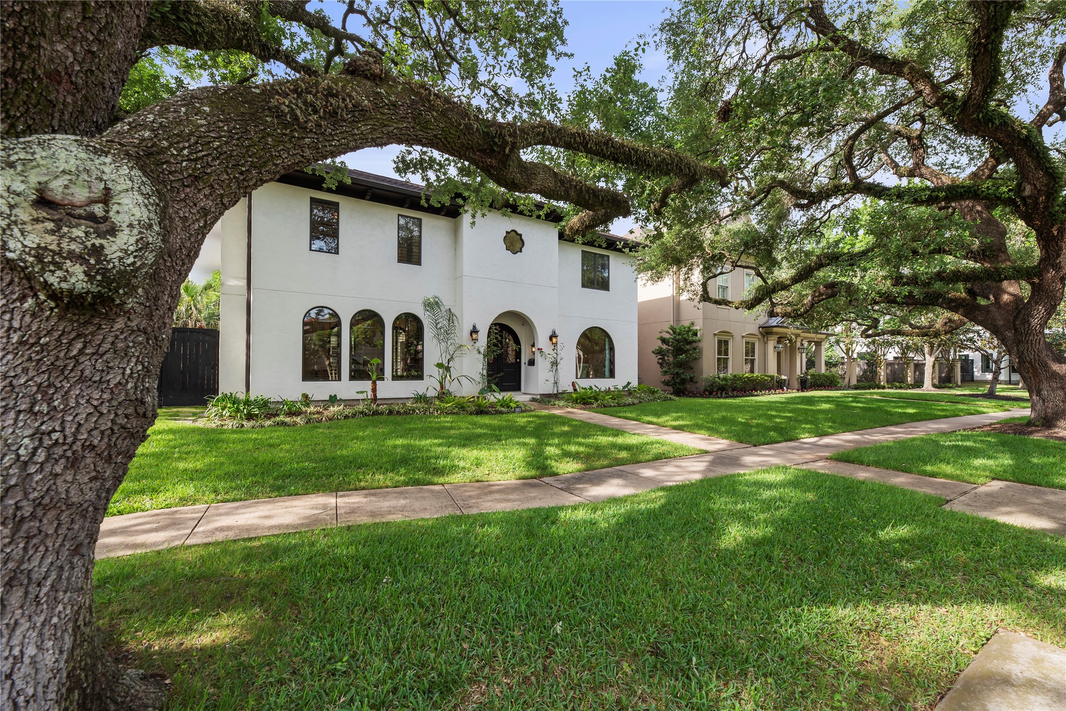 3803 Drake Street Houston, TX 77005 - Photo 32 of 32 a view of a white house with a big yard and large trees