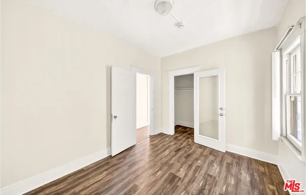 a view of a room with wooden floor and window