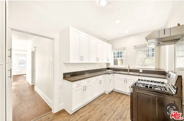 a kitchen with stainless steel appliances a sink and a stove