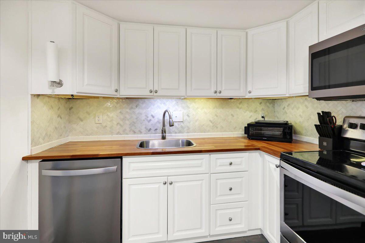 9 A Fairway Road Reading, PA 19607 - Photo 9 of 22 a kitchen with white cabinets and white appliances