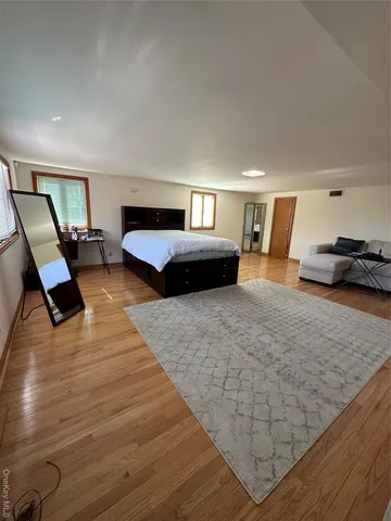 a bedroom with a bed window and couch