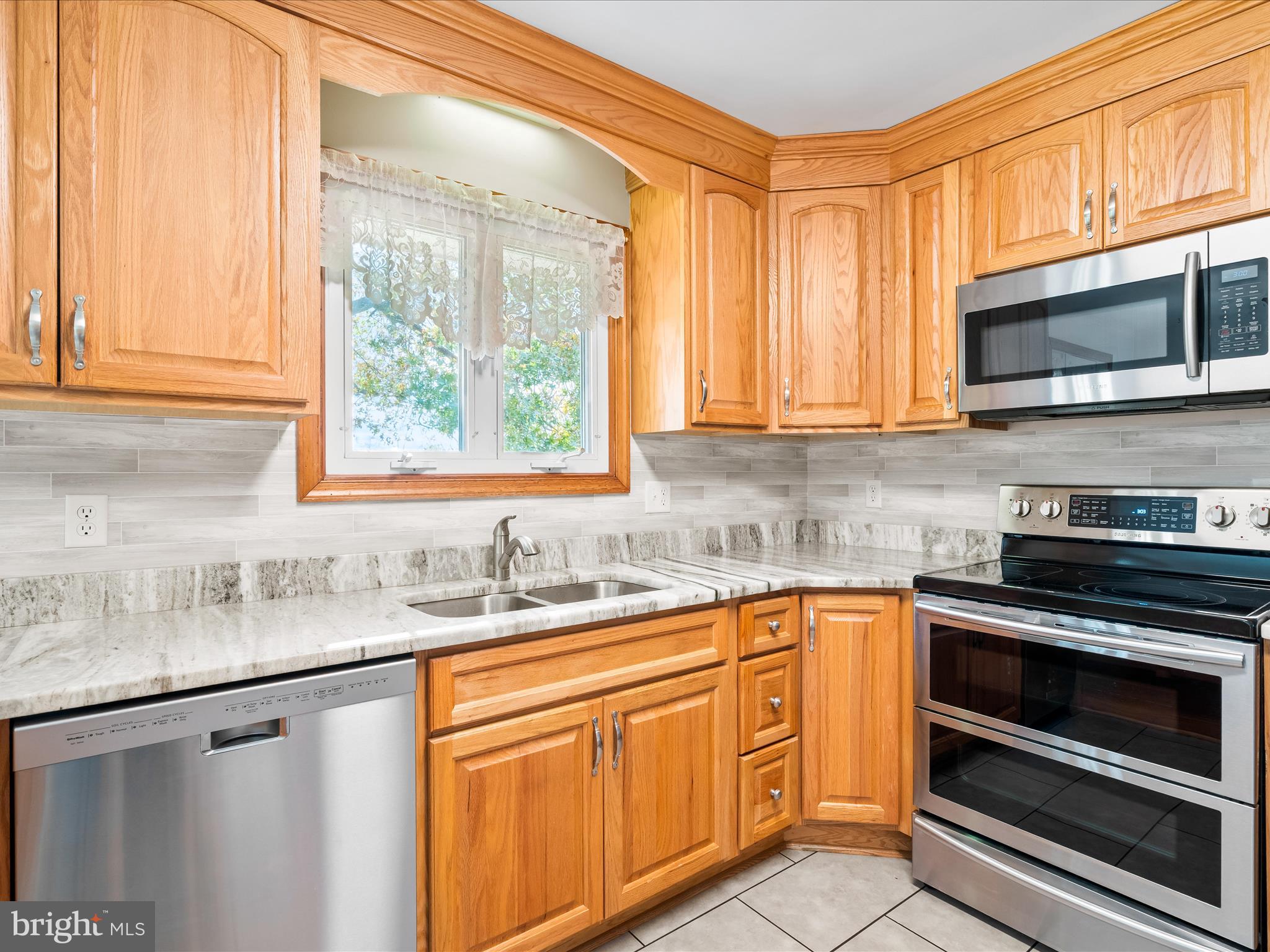 7429 Lewistown Road Thurmont, MD 21788 - Photo 16 of 68 a kitchen with stainless steel appliances granite countertop a sink and cabinets