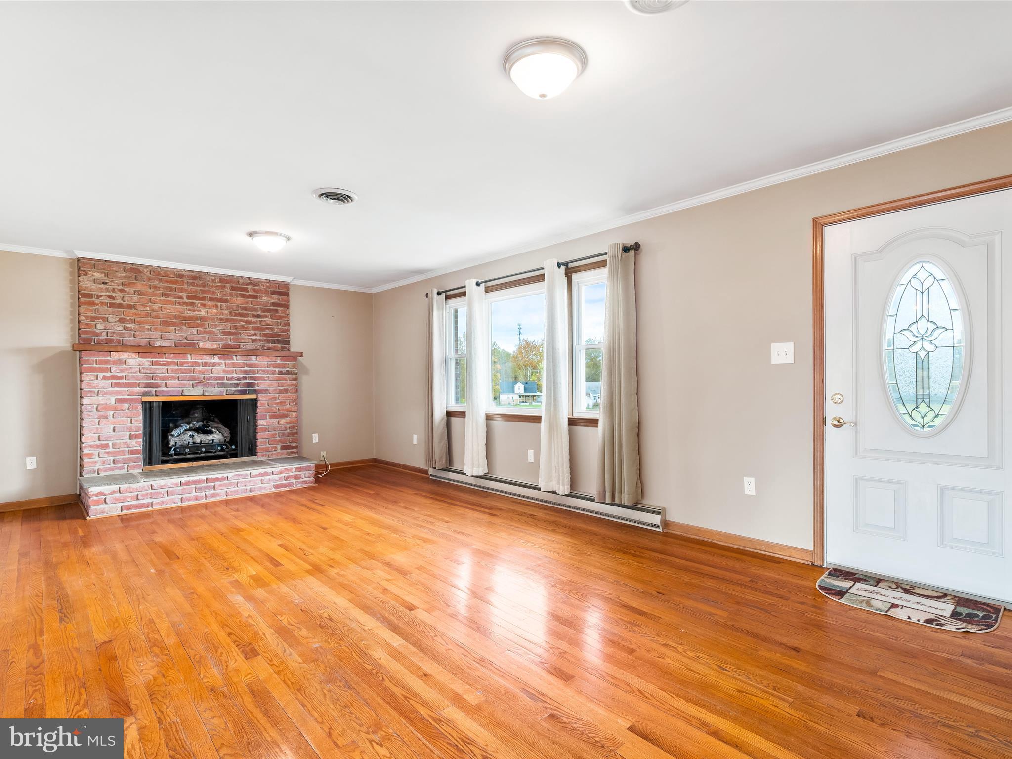 7429 Lewistown Road Thurmont, MD 21788 - Photo 19 of 68 a view of an empty room with a fireplace and a window