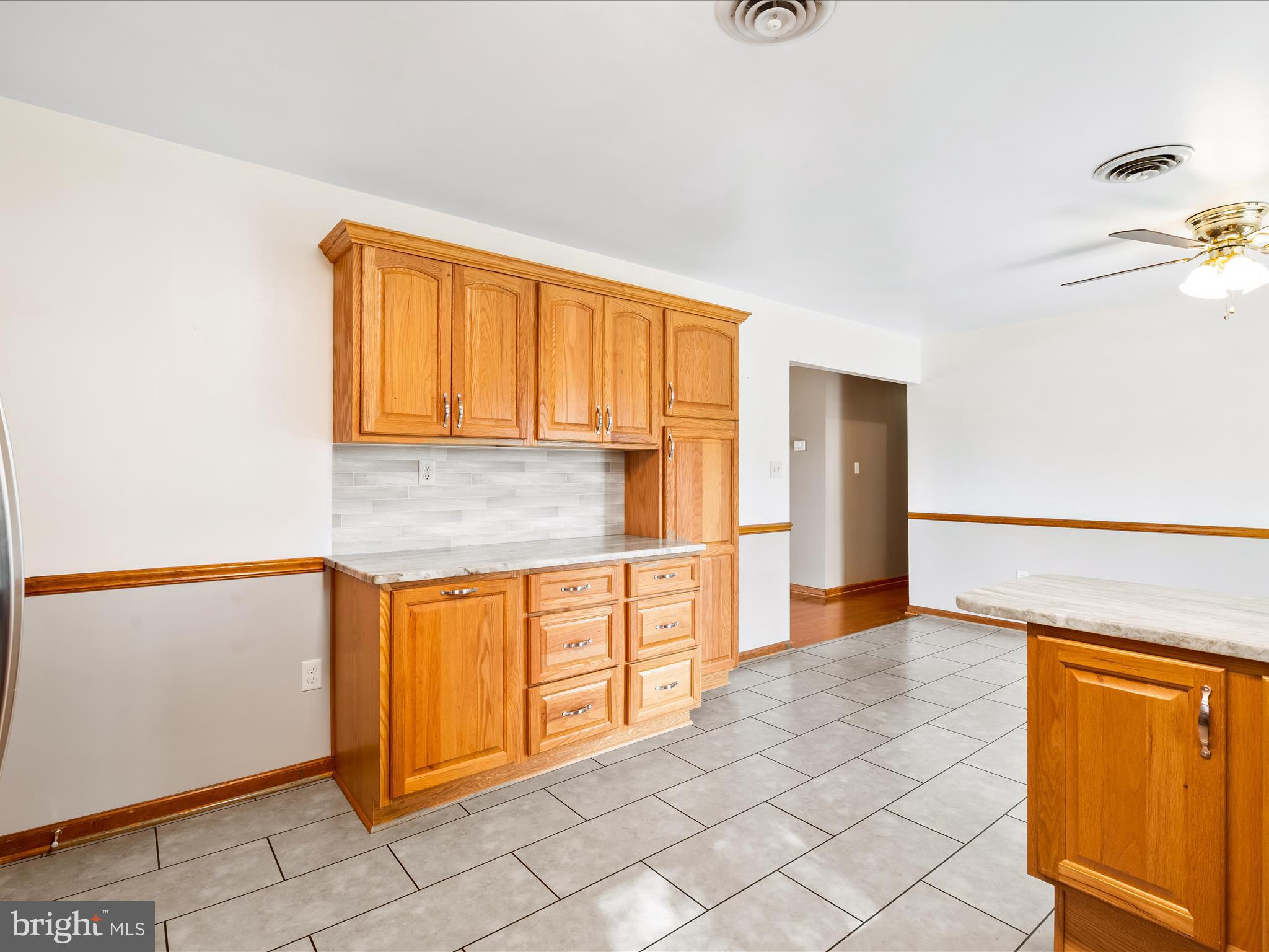 7429 Lewistown Road Thurmont, MD 21788 - Photo 25 of 68 a kitchen with granite countertop a refrigerator and cabinets
