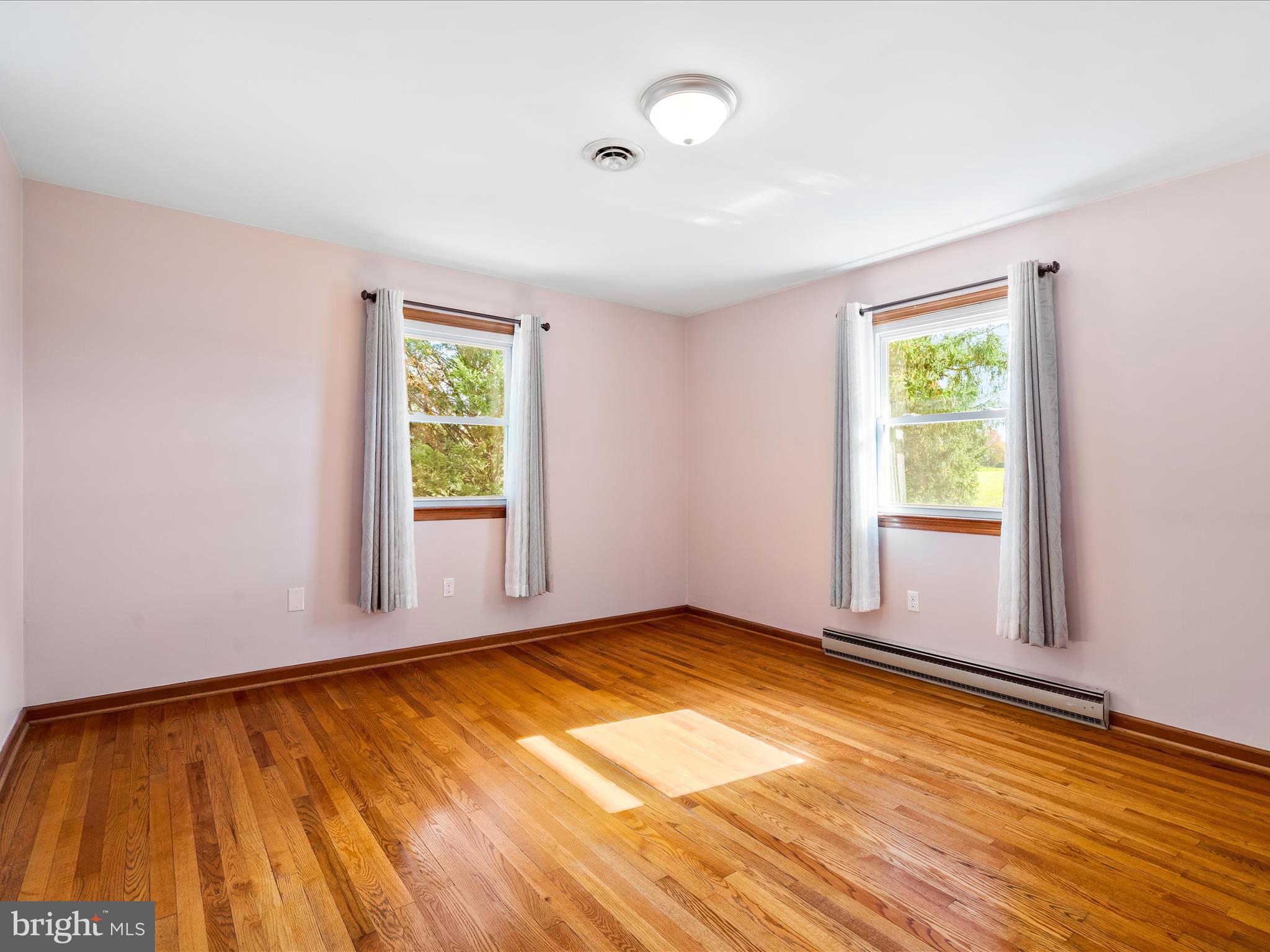 7429 Lewistown Road Thurmont, MD 21788 - Photo 26 of 68 a view of an empty room with wooden floor and a window